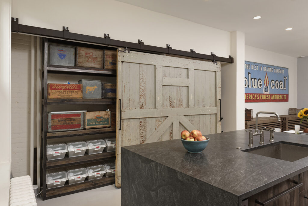 BOWA design build row home renovation in Washington, DC industrial kitchen with barn door pantry | Contemporary / Modern