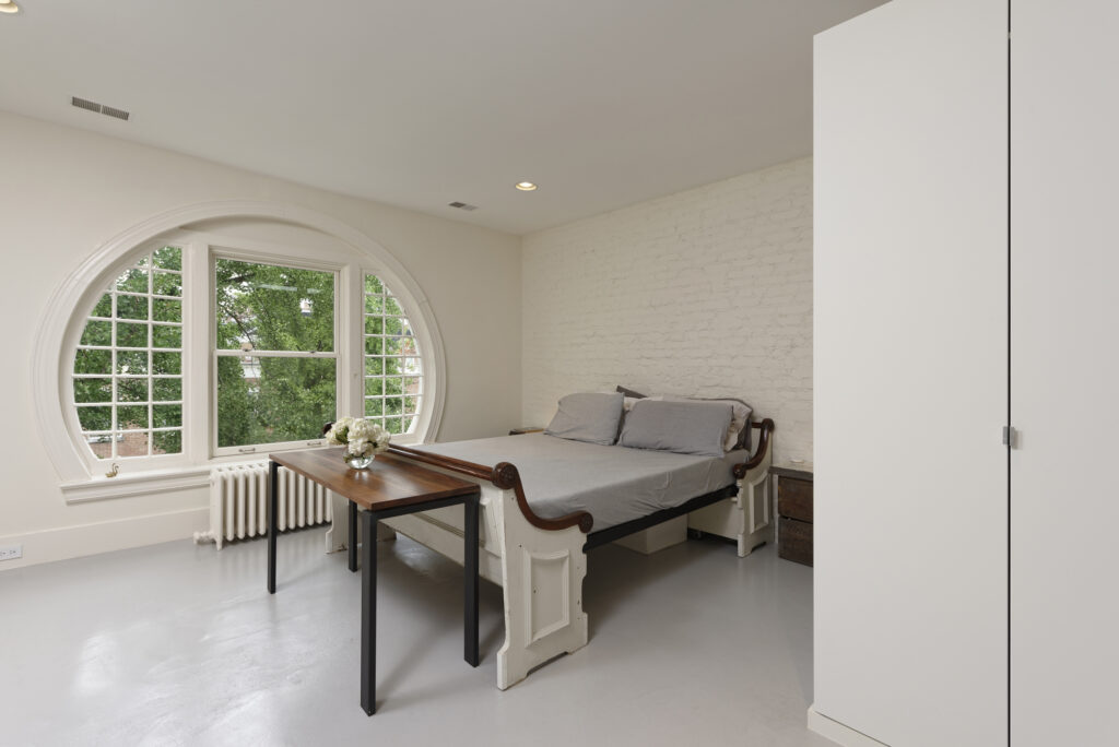 BOWA design build row home renovation in Washington, DC Master Bedroom with Round Window | Contemporary / Modern